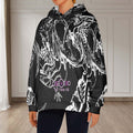 Chasing The Dragon Women's Flannel Hoodie in bold black and white design, showcased in a bright indoor setting.